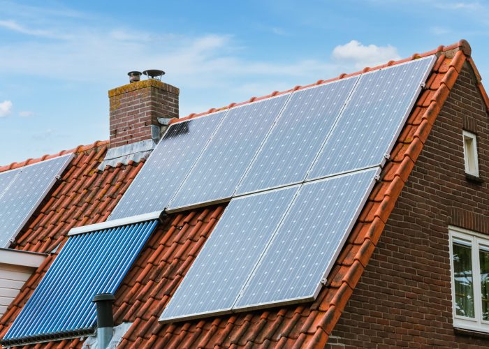 House with solar panels on the roof. Modern ecological energy resource. Green energy by sun